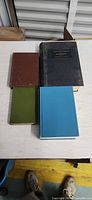 All four books laid out showing covers