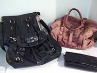 Group shot showing all three handbags and wallet