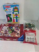 Group shot showing all four items: Melissa & Doug wooden blocks box, Ravensburger Wonder Woman puzzle box, Avengers micro-block pouch, loose bag of bricks