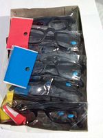 Box containing multiple individually wrapped black frame reading glasses