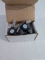 Open box showing multiple grey retractable ID holders