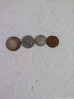 Front view of four coins side-by-side