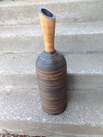 Full view of mango wood vase on stairs