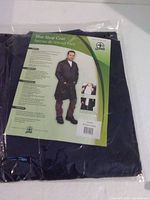 Front of packaged coat showing product insert with image of coat and wearer