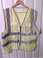 Front view of yellow hi-vis vest showing pockets and reflective stripes