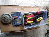 Overall view of socket set disc, driver bit set and bin of loose tools