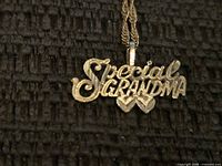 Front view of 14k gold pendant showing “Special Grandma” text and hearts