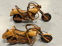 Both wooden motorcycle models side by side displaying overall design and scale.