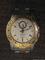 Front view of Bulova two-tone wristwatch showing dial, bezel and branding