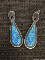 Front view of both earrings showing blue opal inlay and design