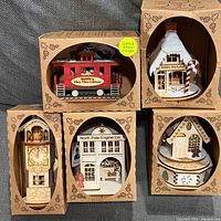Front view of five boxed Ginger Cottages ornaments