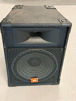 Front view of JBL MR825 showing grille, woofer and horn