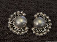 Front view of sterling silver dome earrings showing design details