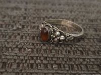 Front view showing cabochon stone and decorative sterling setting