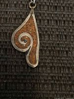 Front of pendant showing design and inlay