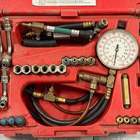 Open case showing gauge, hoses, adapters and fittings