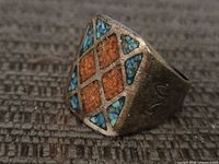 Front view showing diamond face with turquoise and coral inlay