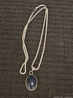 Full view of sterling snake chain necklace with pendant