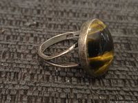 Side view of sterling silver ring with tiger's eye cabochon