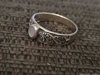 Front view of sterling ring showing cabochon and marcasite scroll design