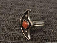 Front view of sterling silver ring showing coral cabochon and crescent setting