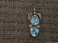 Front view of pendant showing turquoise stones and silver accents