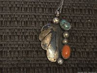 Front of pendant showing turquoise, coral, silver beads