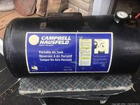 Full view of Campbell Hausfeld portable air tank showing label and carry handle