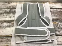 Front view of grey back brace folded