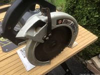 Left side view of Black & Decker circular saw showing blade guard and logo
