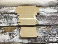bundle of flat-packed cardboard boxes with one assembled example