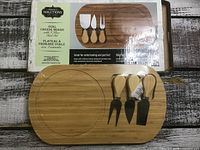 Boxed set showing board and three utensils
