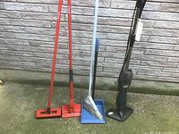 Group shot of all cleaning tools leaning against wall