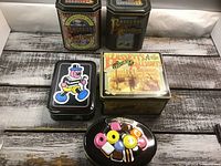 Group shot of five licorice tins showing shapes and artwork