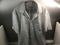 Front view of polka dot short-sleeve shirt on hanger