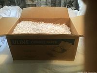 Open Uline carton showing white crinkle paper inside