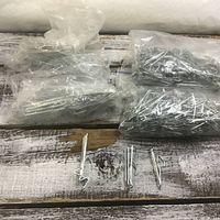 Overview of multiple bags of metal curtain hooks
