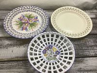 Front view of three plates showing designs and colours