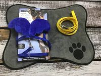 Overall lot: blue winged harness on packaging, yellow leash, grey bone-shaped mat