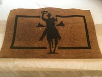 Full view of coir door mat showing cowboy design