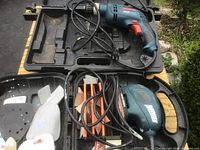 Overall view of open case showing Bosch drill, Black & Decker sander and sanding pads