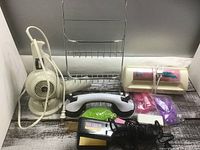 Group view of all items: hair dryer, rack, massager, flat iron, nail dryer, accessories