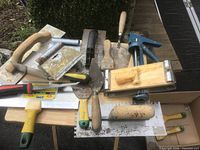 Group of masonry and drywall tools on table