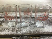 Three measuring cups side by side showing logos and scales
