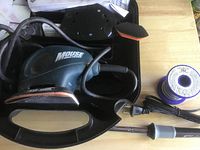 Sander, case interior, soldering iron, solder spool