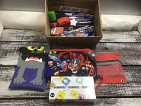 overview of box filled with pencils and pouches plus domino set