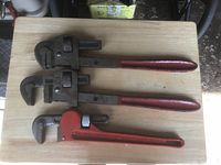 All three pipe wrenches side by side showing sizes, colors, and general condition