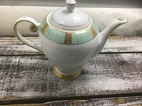 Profile view of Royal Doulton Woodstock teapot showing handle, spout, lid, colour band and gold trim