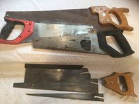 Overview of three hand saws, two back-saw blades and detached handle