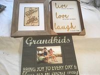 All three framed signs displayed together